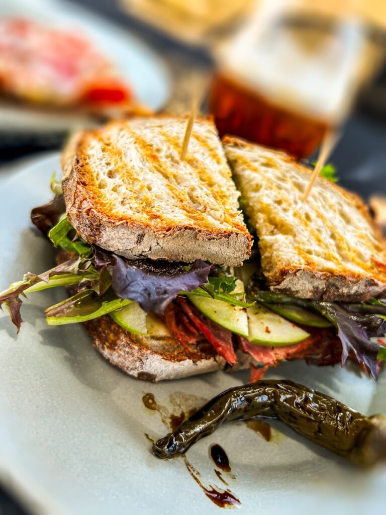 a sandwich with lettuce and tomato